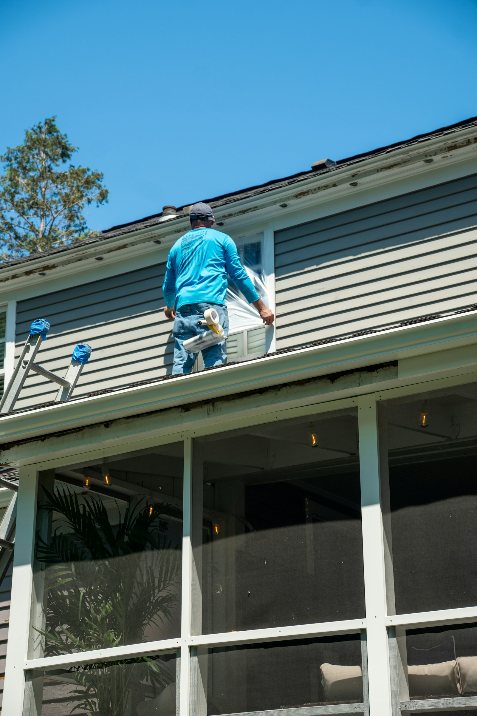 Painter working along a rooftop edge