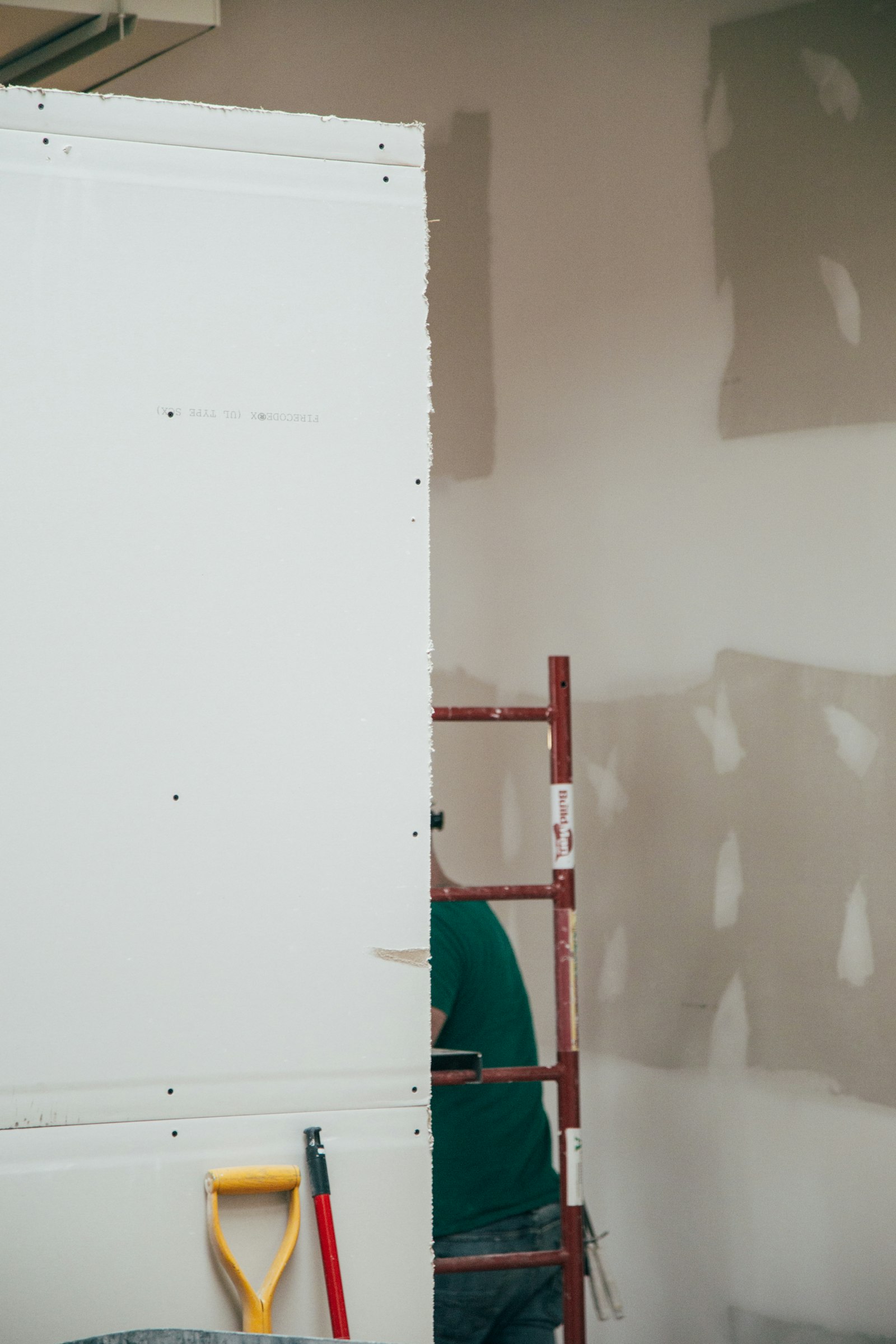 Drywall panel being fitted before painting